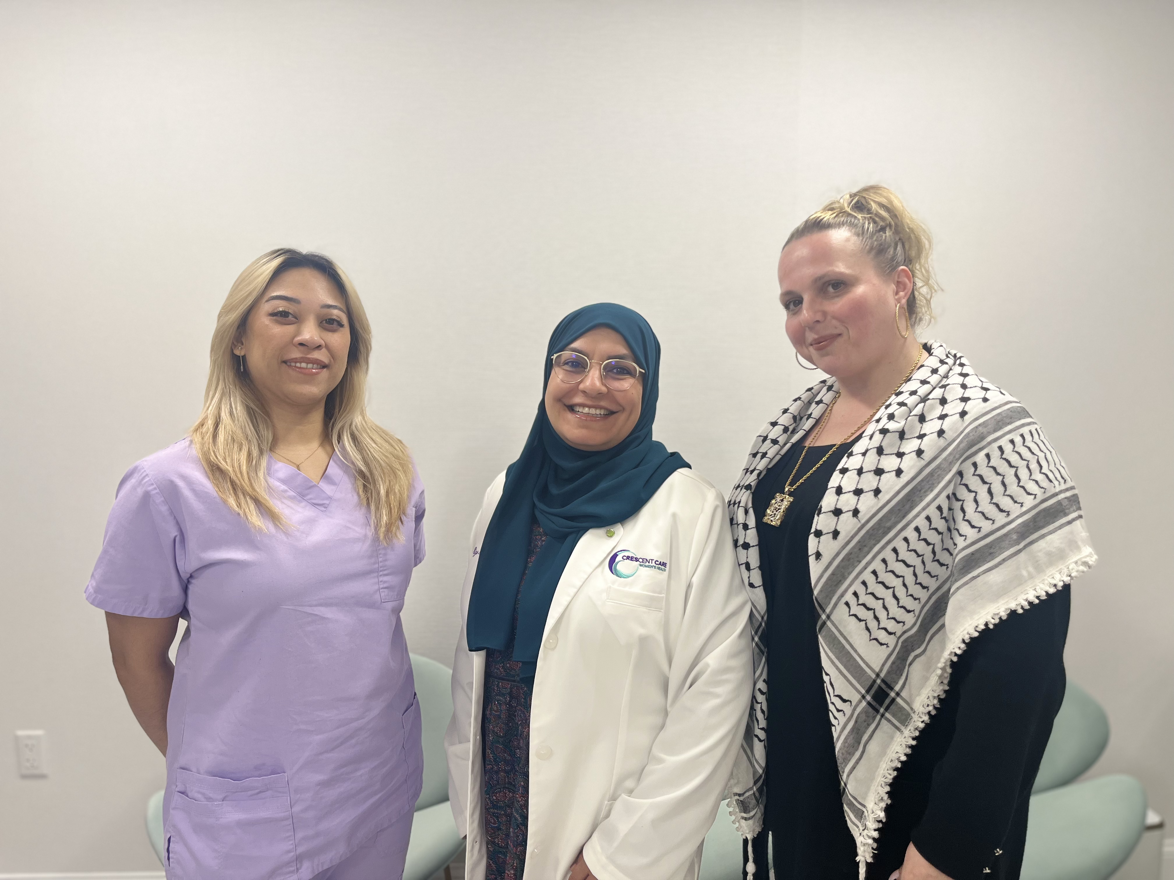 Three employees of CCWH smiling in the CCWH office